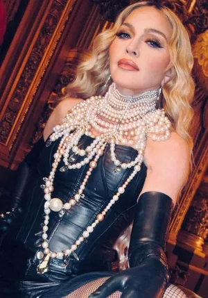 Madonna pairs black corset with pearl necklaces, fishnets in new pictures